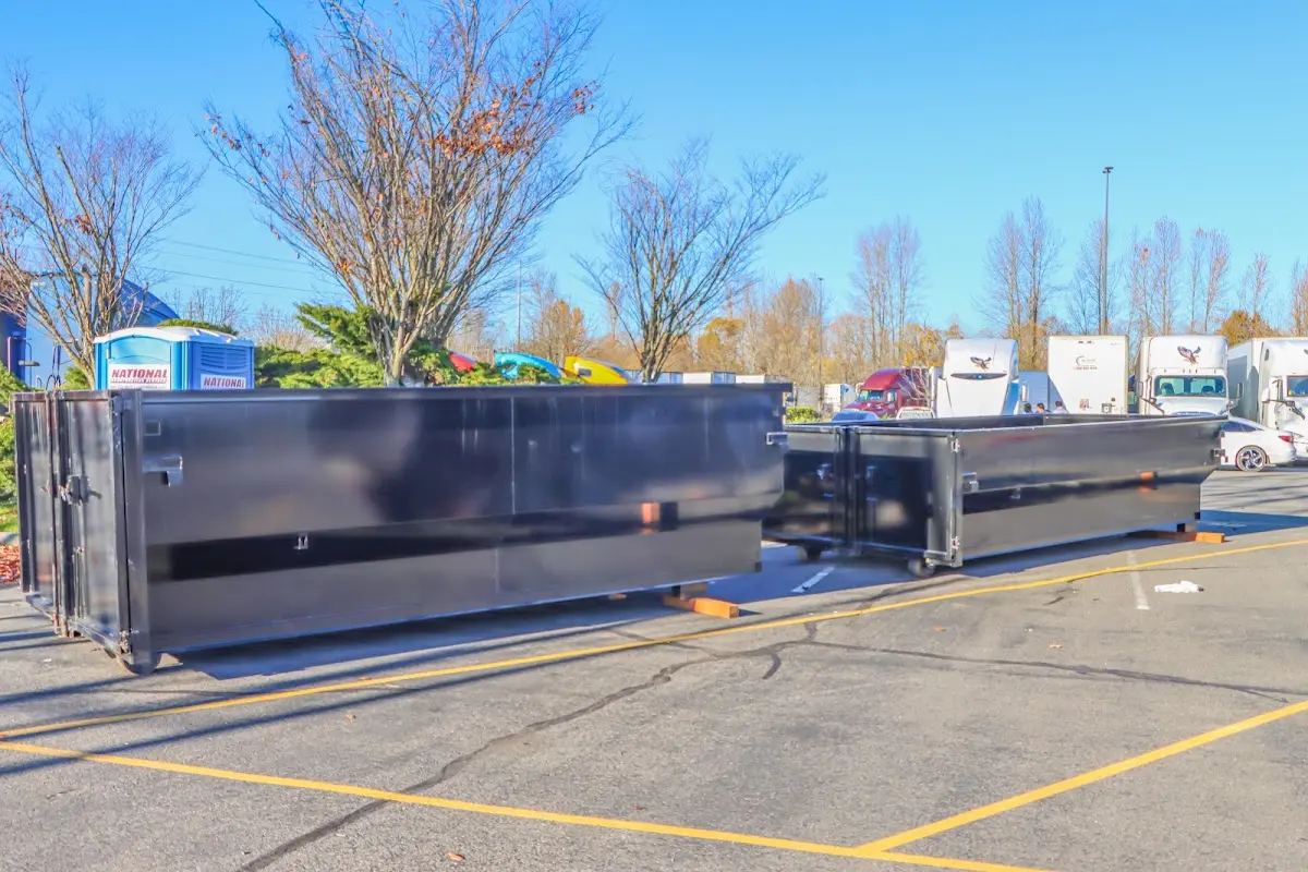 Professional dumpster rental service with roll-off container on residential driveway in Belchertown